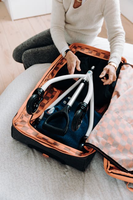 A person sits on a light-colored sofa, wearing a cream-colored sweater and grey trousers, with their hands resting on the edge of an open orange checkered delivery bag. The bag contains three sleek, m